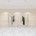 Clothing Store Display Area With Hangers Clothes White Reception Desk Light Colored Walls Marble Floor
