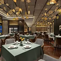 Modern Restaurant Interior with Green Tablecloths Golden Pendant Lights Neat Tables and Wooden Floors