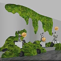 Indoor Landscape Featuring Green Moss Waterfall Wall Silver Sculptures Yellow Spheres Black Stones White Pedestals
