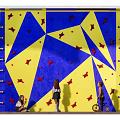 Fun Indoor Kids Climbing Wall with Blue and Yellow Surface and Red Star Shaped Holds