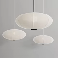 Three White Minimalist Pendant Lights With Paper Shades Hanging Oval Shapes Gray Background