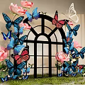 Decorative Window Display With Pink Roses Blue And Pink Butterflies Arched Frame And Green Grass