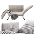 Light Gray Leisure Chair with Striped Upholstery and Cozy Gray Blanket on Black Metal Legs