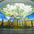 Modern Indoor Space Featuring Circular Ceiling Leaf Decorations Tree Structure And Large Screen Natural Landscape