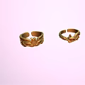 Exquisite Gold Rings With Intricate Carved Patterns On Pastel Pink Background