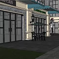 Charming Commercial Street With Storefronts Awnings Outdoor Seating And Street Lamps