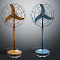 Two Vintage Standing Electric Fans With Brown And Blue Bases And Metal Grills