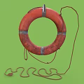 Orange Standard Life Lifebuoy With Hanging Rope On Green Background