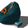 Green Bean Bag Chair with Orange Plush Toy and Gray Blanket and Books Stacked Beside