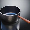 Sleek Black Cooking Pot With Wooden Handle Smooth Surface And Reflection For Daily Kitchen Use