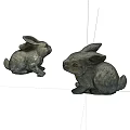 Two Gray Sitting Rabbit Dolls As Decorative Figurines On White Background