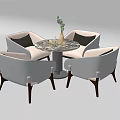 Modern Round Marble Table With Four White Upholstered Chairs And Decorative Vase With Green Plants