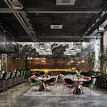 Elegant Modern Restaurant Interior With Green Bar Seats Crystal Chandeliers And Greenery