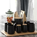 Glass Jar With Red Candies Paper Coffee Bag And Black Mugs With Wooden Lids