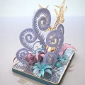 Handcrafted Decorative Sculpture With Golden Geometric Structure And Colorful Paper Flowers On Black Striped Tray