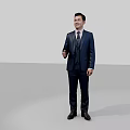 Man in Dark Blue Suit With Tie Standing Against Gray Background