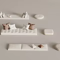 Modern White Sofa Set With Brown Pillows And Round Cushioned Ottomans