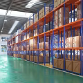 Efficient Industrial Warehouse With Metal Racking Cartons Worker Forklift And Green Floor