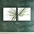Two Green Leaf Plant Paintings in White Frames on Dark Green Wall
