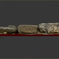 Handmade Wood and Stone Craft Pieces with Rough Surfaces on Red Display Base