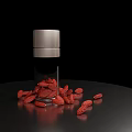 Goji Berries in Glass Bottle with Scattered Berries on Black Surface