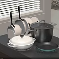 Assorted Kitchen Cookware With Covered Pots And Frying Pans On Black Countertop