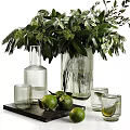 Decorative Ornament Set With Transparent Glass Vases Green Foliage Glass Cups Limes And Black Tray