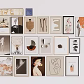 Diverse Framed Artworks Collection on White Wall with Various Styles and Designs