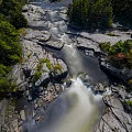 Scenic Natural Microtopography with Flowing River Rocks and Lush Green Trees