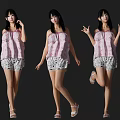 Woman Wearing Pink Camisole Patterned Shorts White Sandals In Three Different Poses Against Dark Background