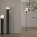 Modern Floor Lamps In Interior With White Spherical Lampshade Black Stand And Green Plant Branches