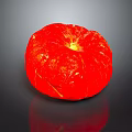 Red Round Textured Household Decorative Item On Black Reflective Surface