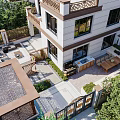Serene Garden Landscape With Wooden Deck Outdoor Grill Area Tables Chairs And Lush Greenery