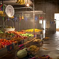 Colorful Fresh Fruits at Market Stalls With Hanging Decorations and Clock
