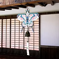 Traditional Japanese Butterfly Wind Chime Pendant With Colorful Floral Patterns Hanging In Wooden Interior