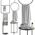 Soft Gray Towels Hanging And Rolled Displayed On Stands With Bath Products