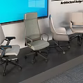 Five Modern Office Chairs In Different Designs Showcased With Large Screen Backdrop
