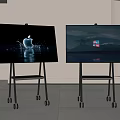 Two Televisions on Wheeled Stands with Apple Logo Display and Windows Logo Screen