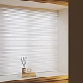 White Horizontal Blinds For Window Interior With Decorative Aromatherapy Bottles And Soft Natural Light