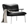 Black Leather Leisure Chair with Metal Frame Armrests and Light Gray Blanket
