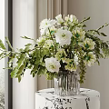 White and Green Flowers in Glass Vase on White Black Pattern Round Table with Leaves