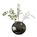Round Glass Vase With Green Leaves And Small Branches Floral Arrangement