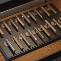 Various Metal And Wooden Furniture Handles Displayed On Wooden Tray With Stylish Designs