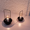Decorative Ornament Combination Of Black Metal Candle Holders With Lit White Candles In Various Sizes