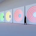 Colorful Concentric Circles Background Wall with Standing Figure in Modern Interior