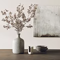 Vase with Dried Flowers on Wooden Tabletop with Stacked Bowls and Abstract Painting