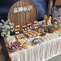 Delicious Dessert And Fruit Platter Display With Floral Decor Wooden Frames Brand Logo At Event