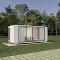 Modern White Container House on Green Grassland with Trees and Glass Doors