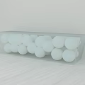 Transparent Acrylic Stool Filled With White Balls On Light Wooden Table
