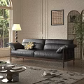 Black Leather Three Seater Sofa With Wooden Legs And Accent Pillow In Sunlit Living Room
